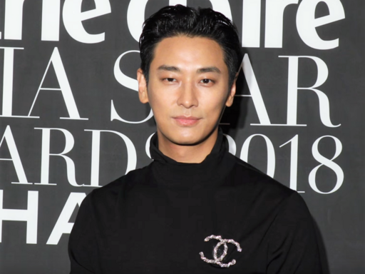 Ju Ji-hoon in a black suit posing at a public event