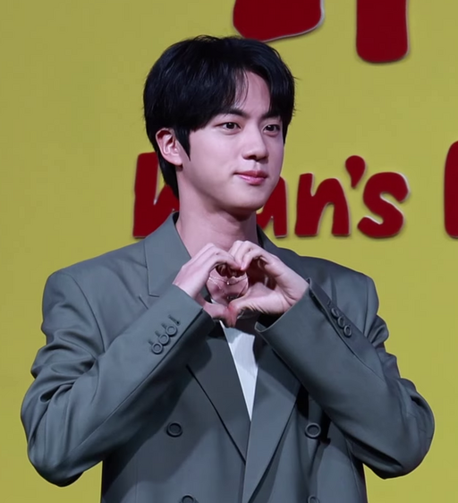 BTS’s Jin speaking at a press conference in April 2025