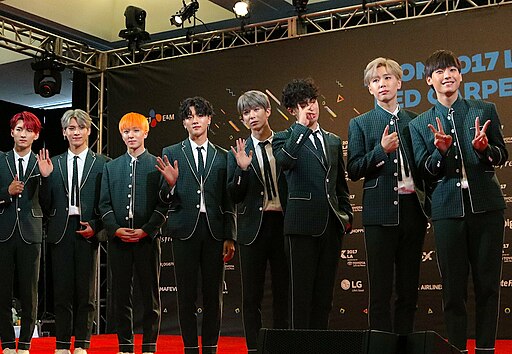 SF9 performing on stage at KCON 2017 LA under blue lights.