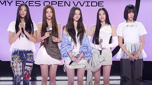 MEOVV members posing before a live performance