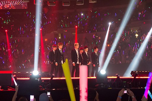 BTS performing live on stage at KCON 2014, captured during their energetic performance.