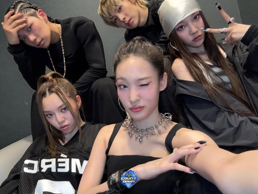 ALLDAY PROJECT poses confidently in stage outfits during debut week.