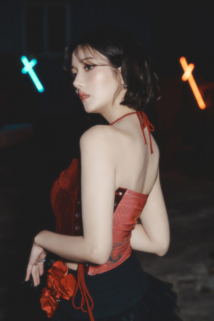 Kwon Eun-bi poses in an elegant black and red concept outfit for her digital single "Hello Stranger."